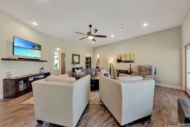 211 Comal Run, Bulverde, TX 78163 - living area with arched walkways, ceiling fan, baseboards, recessed lighting, and wood finished floors