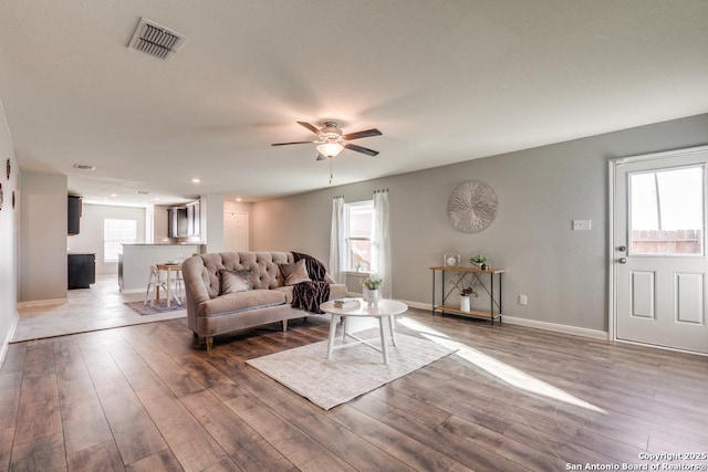 11715 Claudette St, San Antonio, TX 78252 - living room featuring a ceiling fan, wood finished floors, baseboards, and recessed lighting