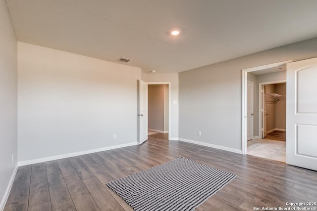 11715 Claudette St, San Antonio, TX 78252 - unfurnished bedroom with wood finished floors, baseboards, and recessed lighting