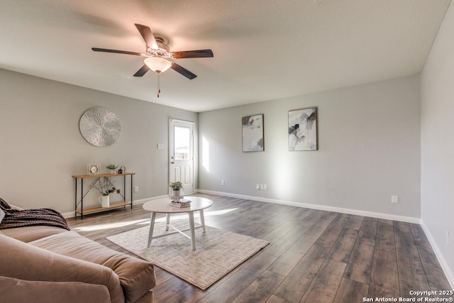 11715 Claudette St, San Antonio, TX 78252 - living room featuring a ceiling fan, dark wood finished floors, and baseboards
