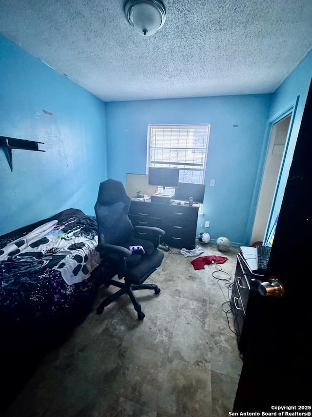 941 Potomac, San Antonio, TX 78202 - bedroom with a desk, a textured ceiling, and concrete flooring