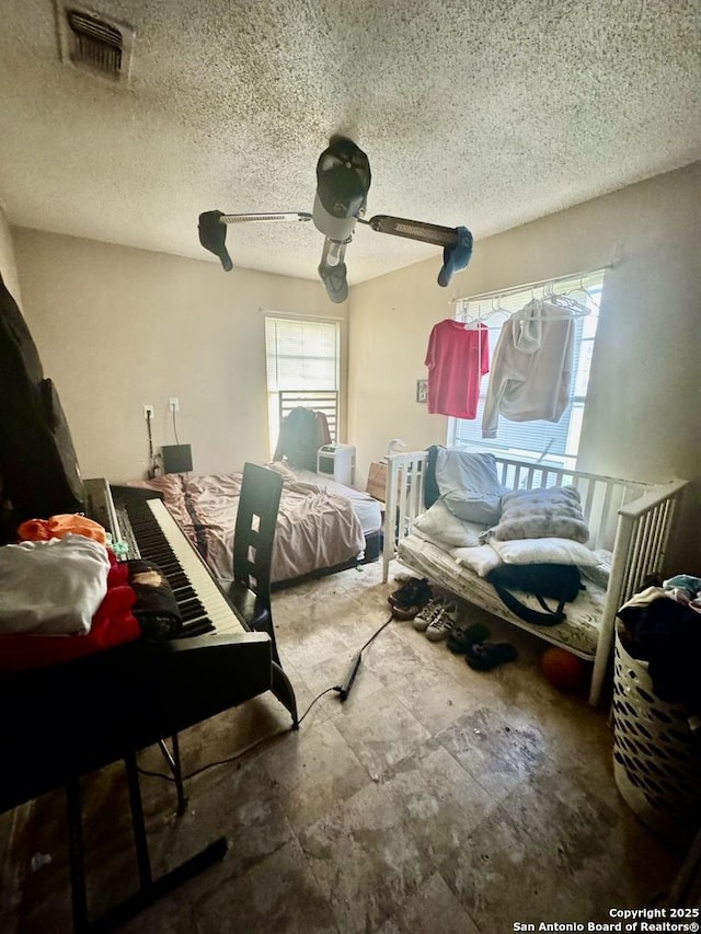 941 Potomac, San Antonio, TX 78202 - bedroom with multiple windows, a textured ceiling, and ceiling fan