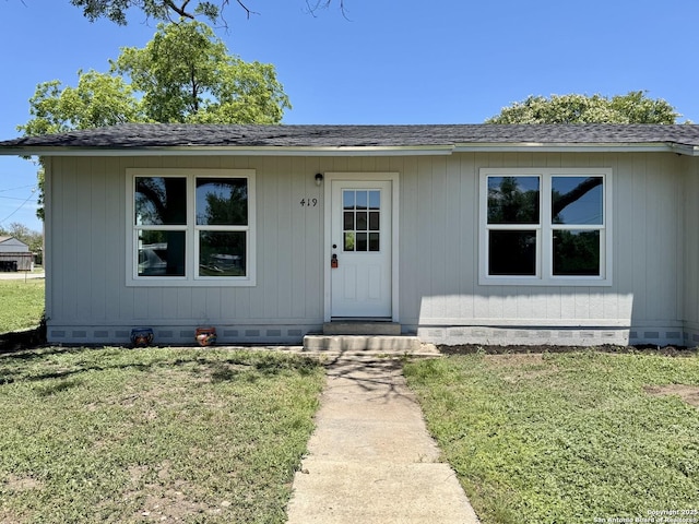 419 W Culberson, Sabinal, TX 78881 - view of front of home featuring crawl space, a front lawn, and a shingled roof