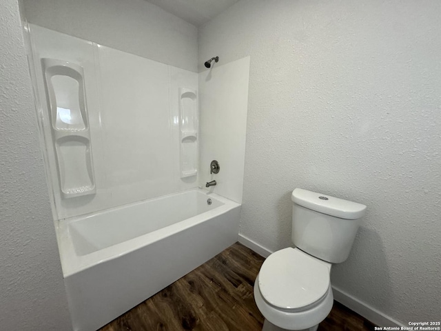 419 W Culberson, Sabinal, TX 78881 - bathroom with wood finished floors, baseboards, toilet, and bathing tub / shower combination