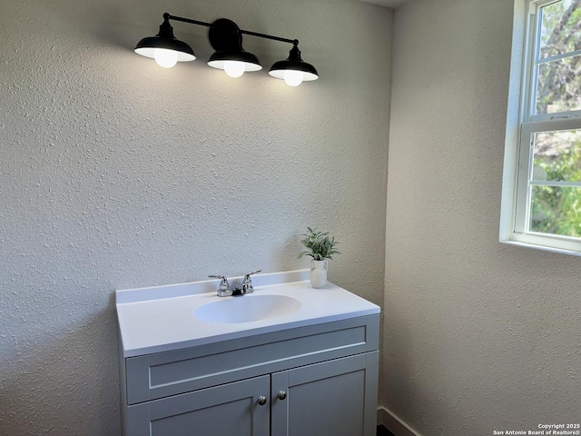 419 W Culberson, Sabinal, TX 78881 - bathroom featuring vanity, healthy amount of natural light, and a textured wall