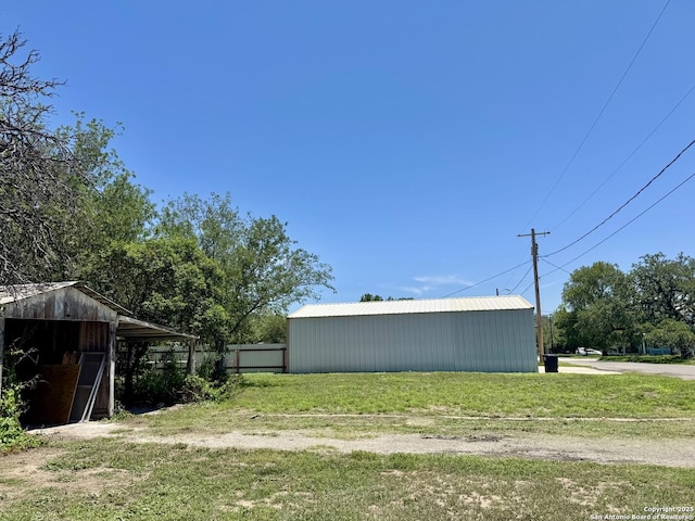 419 W Culberson, Sabinal, TX 78881 - view of grassy yard featuring a pole building and an outdoor structure