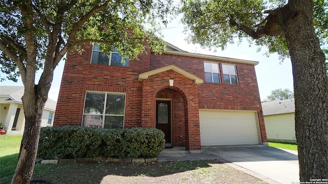 traditional home with brick siding, a garage, and concrete driveway