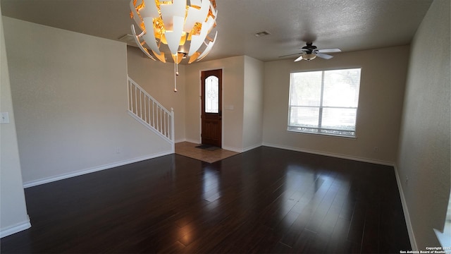 foyer featuring stairway, wood finished floors, ceiling fan, and baseboards