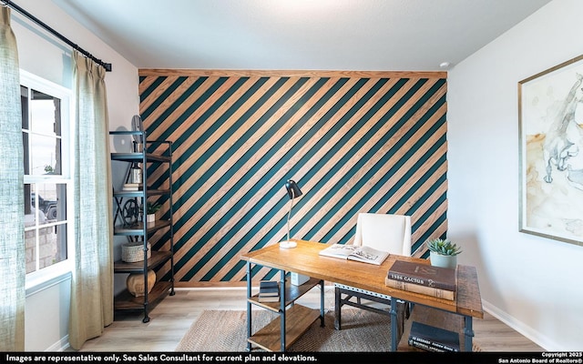 1216 Sweden, Seguin, TX 78155 - home office featuring an accent wall, baseboards, light wood-type flooring, and wallpapered walls