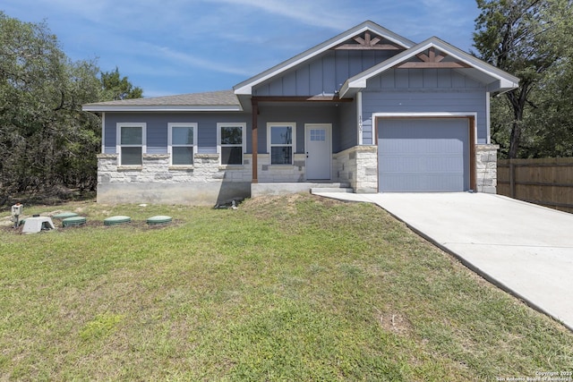 1407 Tanglewood, Spring Branch, TX 78070 - view of front facade with a garage, stone siding, concrete driveway, and board and batten siding