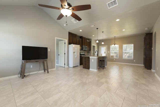 1407 Tanglewood, Spring Branch, TX 78070 - unfurnished living room featuring ceiling fan, recessed lighting, baseboards, lofted ceiling, and a sink