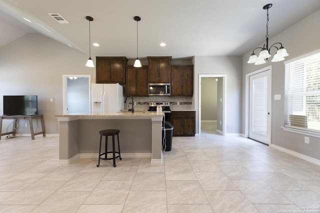 1407 Tanglewood, Spring Branch, TX 78070 - kitchen with stainless steel microwave, white fridge with ice dispenser, tasteful backsplash, a sink, and dark brown cabinetry