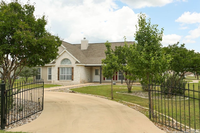1181 County Road 4516, Castroville, TX 78009 - view of front facade with stone siding, a shingled roof, curved driveway, a chimney, and stucco siding