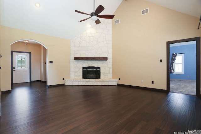 1181 County Road 4516, Castroville, TX 78009 - unfurnished living room featuring a ceiling fan, high vaulted ceiling, wood finished floors, arched walkways, and baseboards