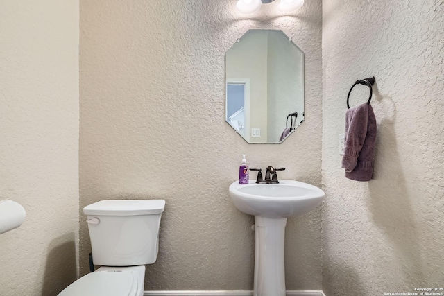 bathroom featuring toilet and a sink