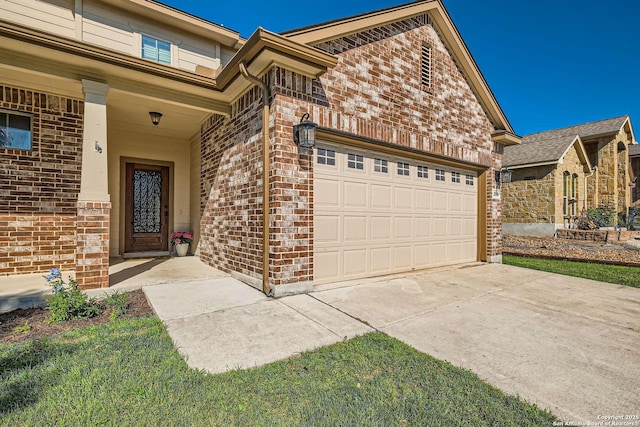 view of front of home with brick siding, an attached garage, and concrete driveway