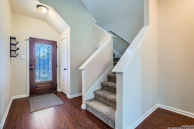 foyer featuring wood-type flooring, baseboards, and stairway