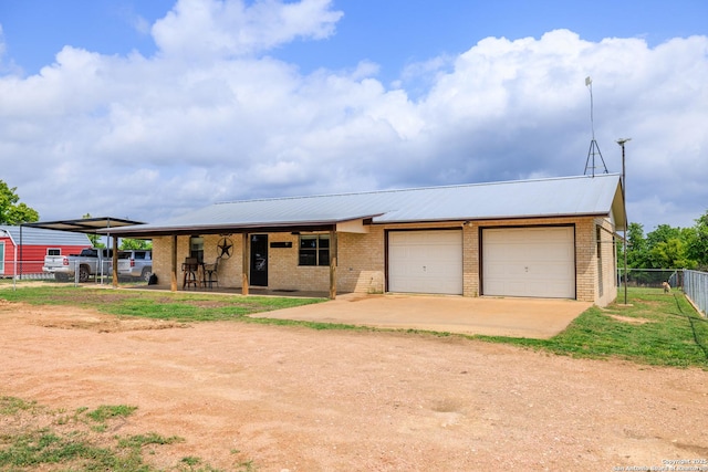 2050 Adj Ln, Fredericksburg, TX 78624 - view of front facade featuring brick siding, dirt driveway, fence, and metal roof