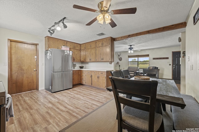 2050 Adj Ln, Fredericksburg, TX 78624 - kitchen featuring freestanding refrigerator, a ceiling fan, a textured ceiling, light countertops, and light wood-type flooring