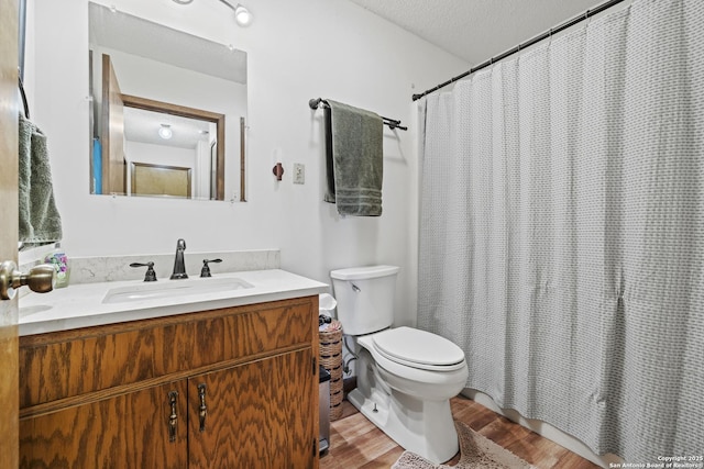 2050 Adj Ln, Fredericksburg, TX 78624 - bathroom with wood finished floors, toilet, vanity, and curtained shower