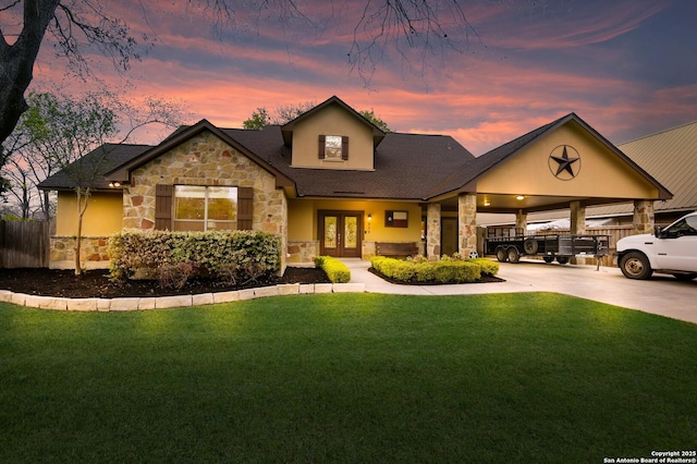 315 E Klein, New Braunfels, TX 78130 - view of front facade with stone siding, french doors, concrete driveway, and an attached carport