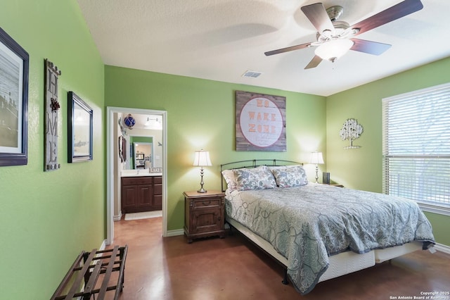 315 E Klein, New Braunfels, TX 78130 - bedroom with multiple windows, baseboards, ceiling fan, and connected bathroom