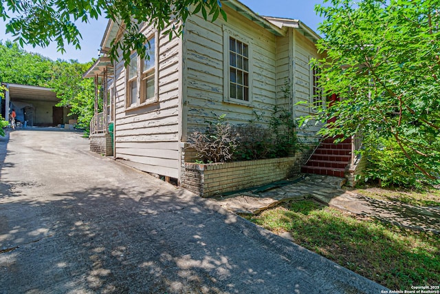 210 Harrison, Alamo Heights, TX 78209 - view of home's exterior with driveway, stairway, and a carport