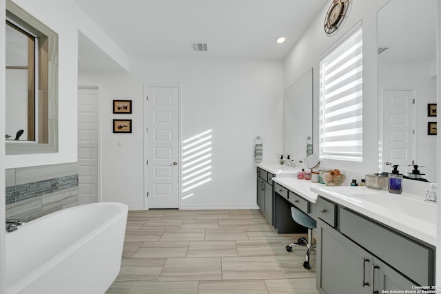 11109 Molly Run, San Antonio, TX 78254 - bathroom featuring a freestanding bath, vanity, and recessed lighting