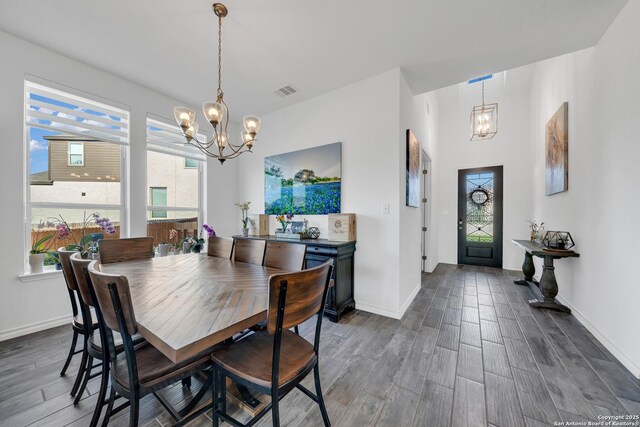 11109 Molly Run, San Antonio, TX 78254 - dining area with a chandelier, dark wood-style flooring, and baseboards