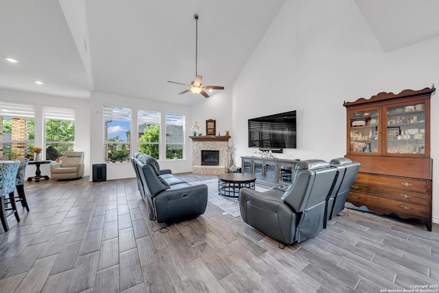 11109 Molly Run, San Antonio, TX 78254 - living area with wood finish floors, a stone fireplace, ceiling fan, high vaulted ceiling, and recessed lighting