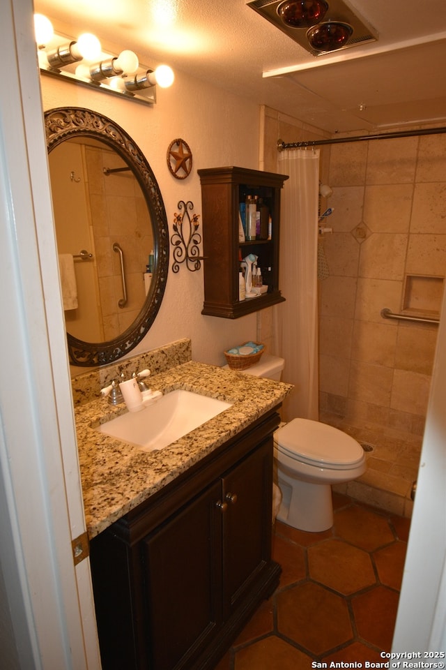 8401 New Braunfels Unit 125, San Antonio, TX 78209 - full bath with a tile shower, toilet, vanity, and tile patterned floors