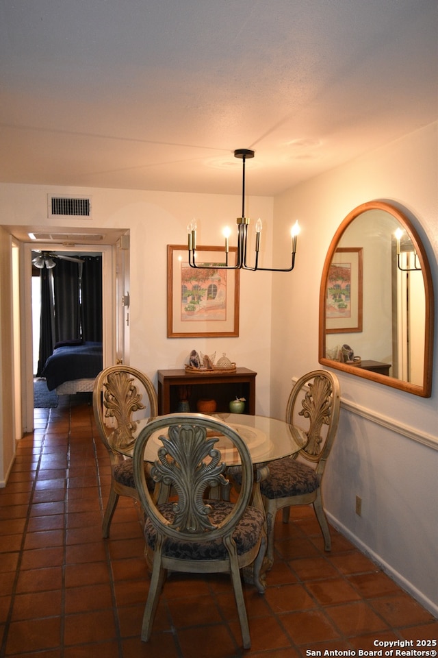 8401 New Braunfels Unit 125, San Antonio, TX 78209 - tiled dining room with a chandelier and baseboards