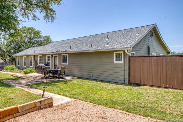 296 Cherokee Dr, Bandera, TX 78003 - back of property featuring a patio and a shingled roof