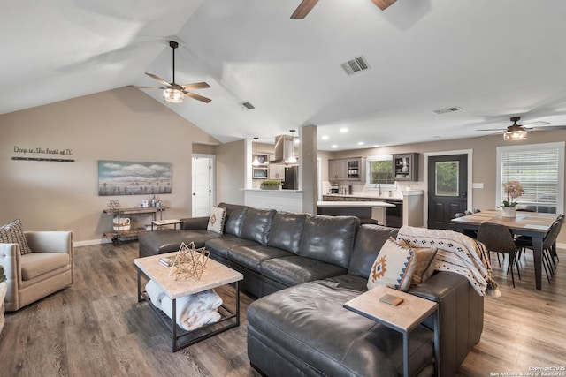 296 Cherokee Dr, Bandera, TX 78003 - living area with a ceiling fan, vaulted ceiling, wood finished floors, baseboards, and recessed lighting