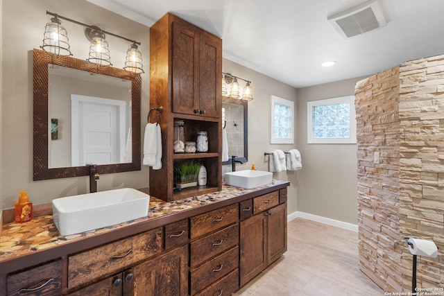 296 Cherokee Dr, Bandera, TX 78003 - full bath with baseboards, double vanity, and tile patterned flooring