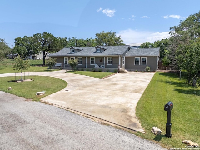 296 Cherokee Dr, Bandera, TX 78003 - view of front facade featuring curved driveway, a front yard, and a shingled roof