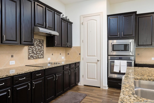 1041 Water Oak, Schertz, TX 78154 - kitchen featuring stainless steel appliances, under cabinet range hood, wood finished floors, and light stone counters