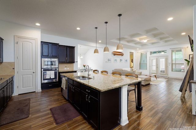 1041 Water Oak, Schertz, TX 78154 - kitchen featuring stainless steel appliances, a sink, open floor plan, a breakfast bar area, and coffered ceiling