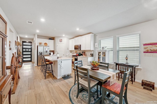10227 Azealia Way, Boerne, TX 78006 - dining area with light wood-style floors, recessed lighting, and baseboards