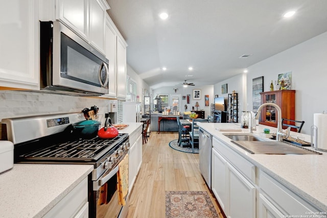10227 Azealia Way, Boerne, TX 78006 - kitchen featuring stainless steel appliances, a sink, light wood-type flooring, recessed lighting, and white cabinets