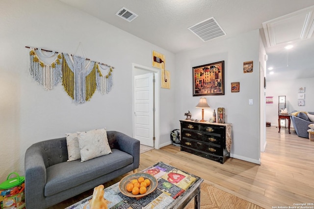 10227 Azealia Way, Boerne, TX 78006 - living area with attic access, light wood-style flooring, and baseboards