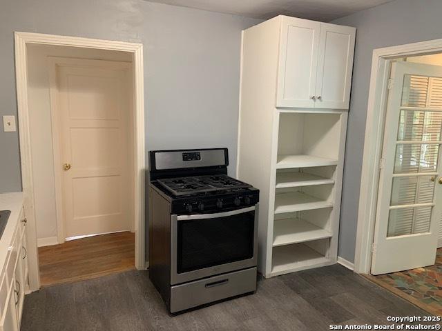 434 Hermine, San Antonio, TX 78212 - kitchen featuring stainless steel gas range oven, dark wood-style flooring, white cabinets, and light countertops