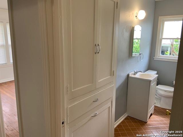 434 Hermine, San Antonio, TX 78212 - half bathroom with toilet, vanity, baseboards, and tile patterned floors