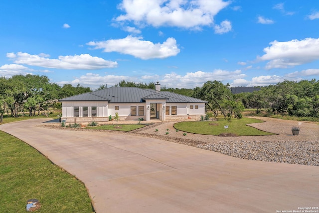 740 Sharp Spgs, Bulverde, TX 78163 - modern farmhouse featuring a standing seam roof, a chimney, concrete driveway, metal roof, and a front yard