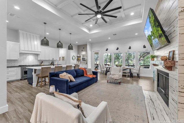 740 Sharp Spgs, Bulverde, TX 78163 - living area with coffered ceiling, recessed lighting, light wood-style flooring, ceiling fan, and a fireplace