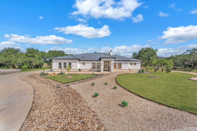 740 Sharp Spgs, Bulverde, TX 78163 - back of property featuring a chimney, a lawn, stone siding, metal roof, and a standing seam roof