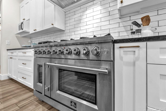740 Sharp Spgs, Bulverde, TX 78163 - kitchen view of stainless steel range, backsplash, white cabinets, light wood-style flooring, and white microwave