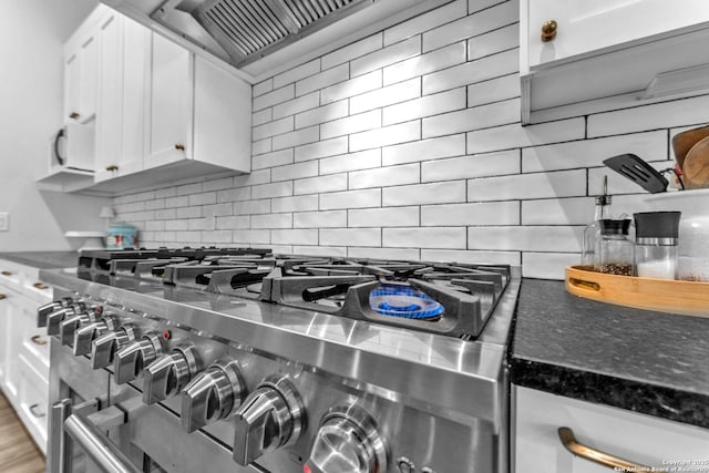 740 Sharp Spgs, Bulverde, TX 78163 - kitchen view of stainless steel range, tasteful backsplash, white cabinets, and wall chimney exhaust hood