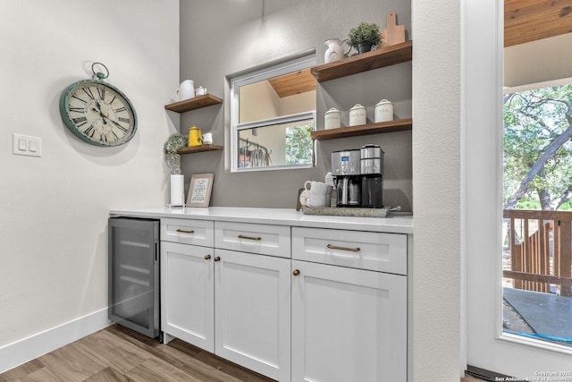 740 Sharp Spgs, Bulverde, TX 78163 - bar with wine cooler, plenty of natural light, light wood-style flooring, and baseboards