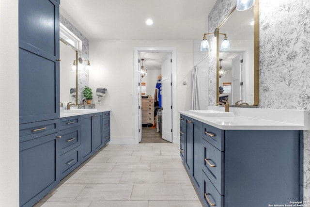 740 Sharp Spgs, Bulverde, TX 78163 - full bathroom with wallpapered walls, two vanities, and baseboards